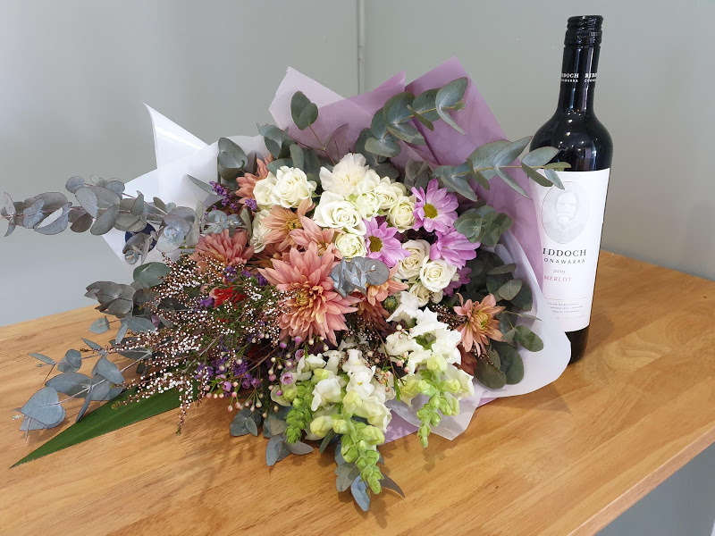 Large flower bunch and a bottle of wine
